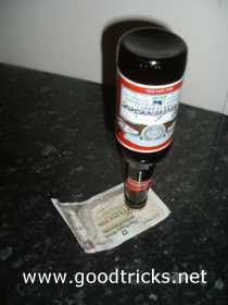 Beer bottle is place upside down on money bill 