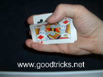 Grip end of pack with fingers and pull off top card with thumb.