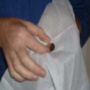 Place coin into handkerchief.