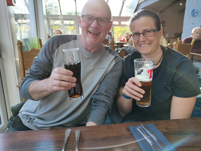 Customers enjoying some fun bar bets in a pub.