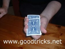 Top card should be pushed forward and deck tilted downwards to hide finger.