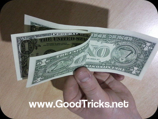 Dollar bills folded toin preparation for magic trick.
