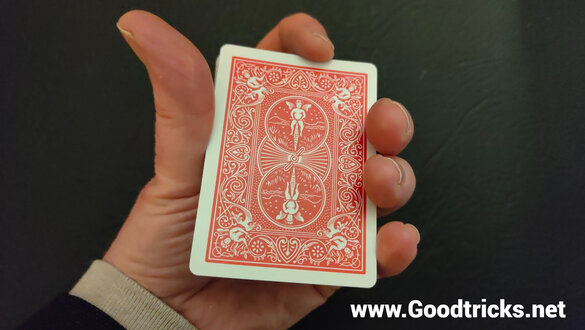 Deck of playing cards held in mechanics grip reday to perform a magic  trick.