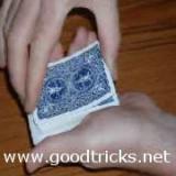Turn up one edge of the top two cards with the thumb of your right hand.