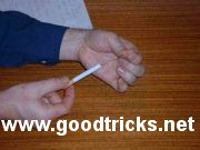 Insert the straightened paperclip into the cigarette.