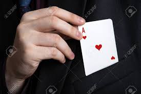 Magician reaching into pocket for ace of hearts playing card. Magic trick image.