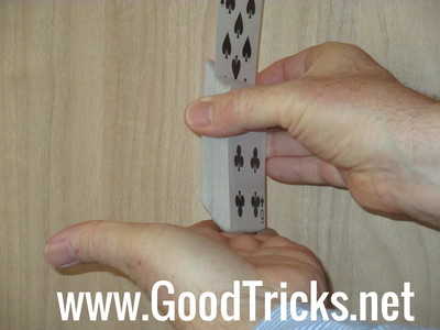 Square up base of pack with other hand to make this rising card trick look smooth.