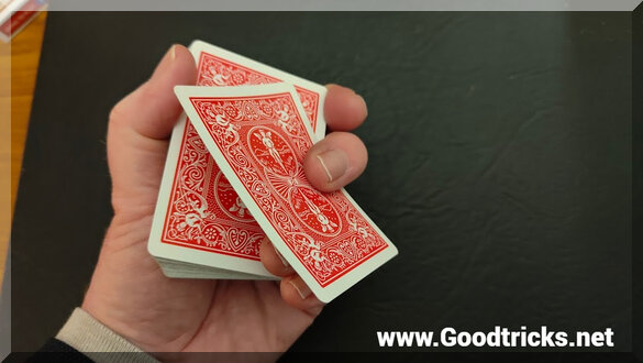 Pulling a playing card off the top of the deck to facilitate a sleight.