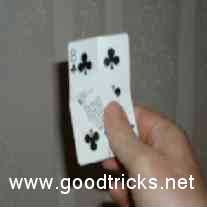 Hold extra piece of card in place with thumb.