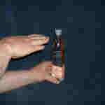 Ketchup sachet is seen to float at the top of the bottle.