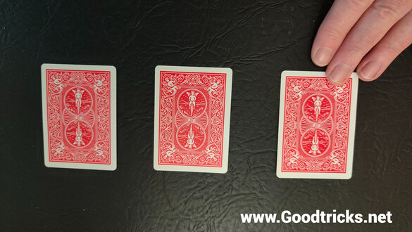 Three playing cards face down.