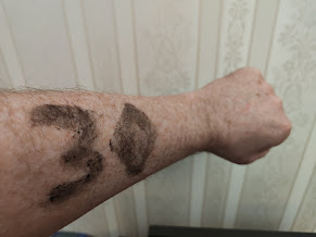 Image of secretly chosen number, written on arm.