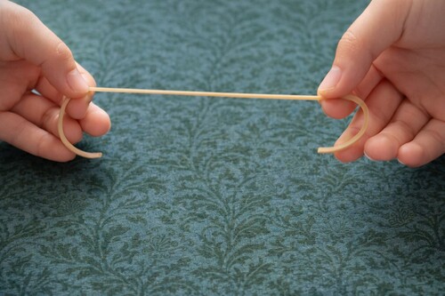 Broken rubber band prepared as one long elastic strand