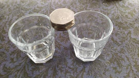 Drink glasses and coins are two popular items that can be used to perform bar magic tricks.