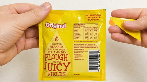 Hand approaching the candy packet