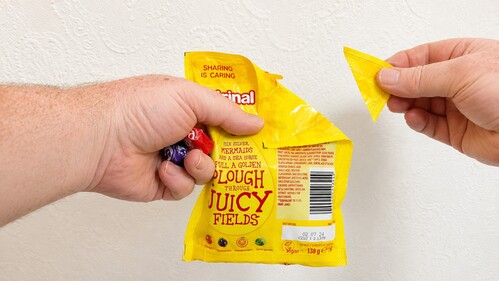 Candy packet folded to simulate an open corner