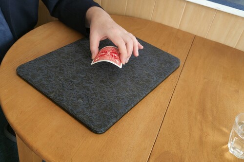 Playing card beginning to bend while resting on the back of the hand