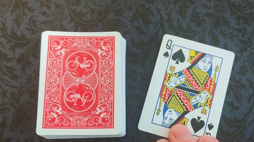 Thought of card being revealed by magician.