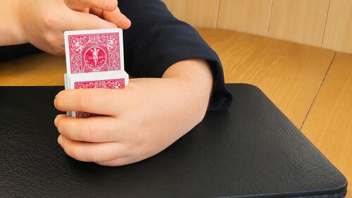 The chosen card beginning to rise from the deck