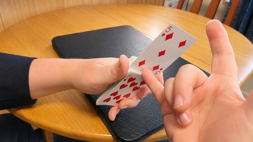 The chosen card rising higher from the deck