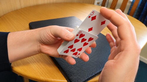 The selected card almost fully risen from the deck