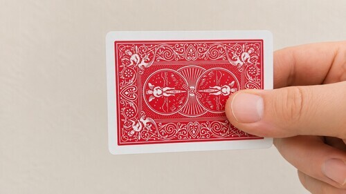 Two playing cards aligned together and gripped at the corner