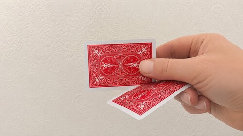 Front card sliding fully behind the second playing card