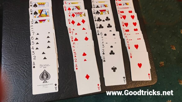 Playing cards set up in new deck order.