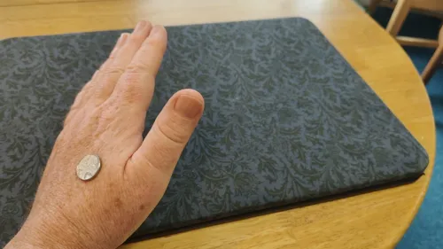 Coin being secretly transferred into the hand during the rubbing action