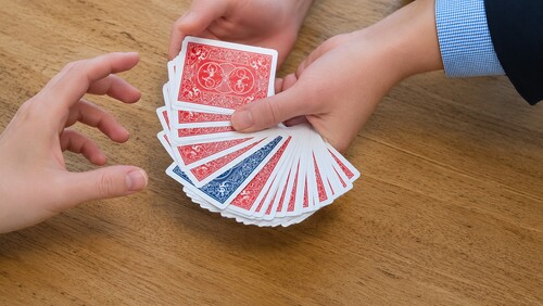 Positioning cards in front of spectator's hand.