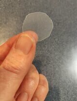 Image of clear plastic disk for use in a beer prank.