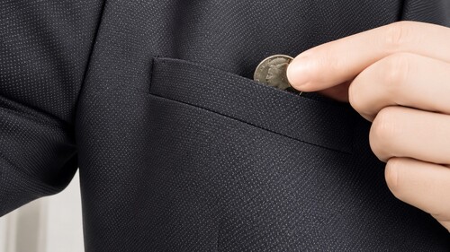 Magnetic coin being secretly dropped into a pocket after the transformation