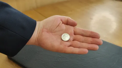 Ring hand waving over the open palm as the coin changes