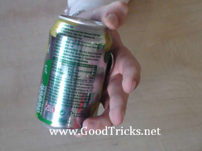 Sliding the coin up the side of the can