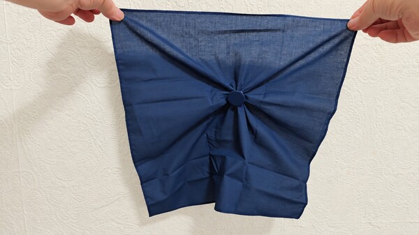 Coin secretly trapped inside the handkerchief