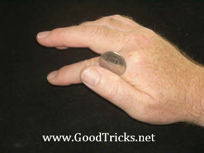 Thumb is used to push up coin onto first finger.