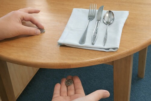 Coin hidden under table.