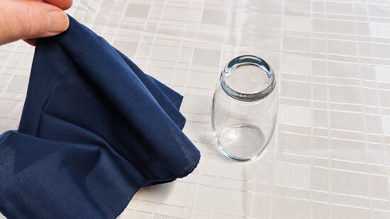 A coin vanishing under a glass.