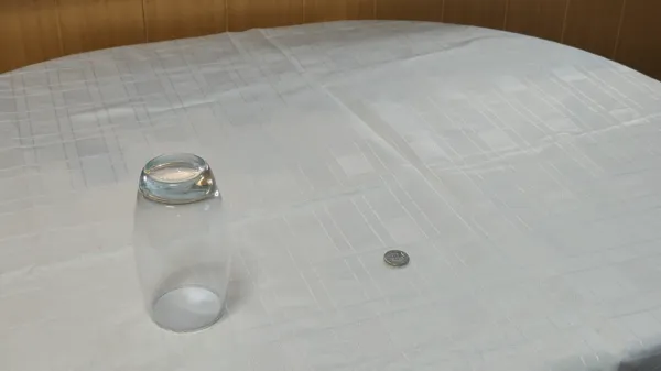 Animated demonstration of a coin vanishing and reappearing under a glass