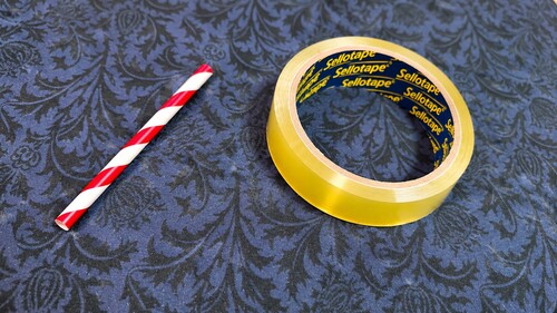 Short straw and clear adhesive tape used for the disappearing toothpick trick
