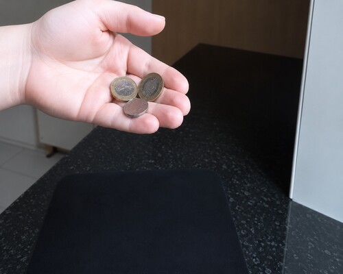Coins being held in hands.