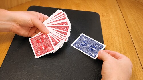 A deck of cards fanned face down for a spectator to choose a card