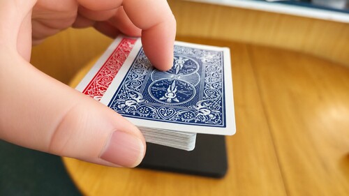 The chosen card slightly outjogged from the top of the deck