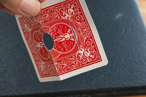 Secret slit cut across the upper part of the playing card