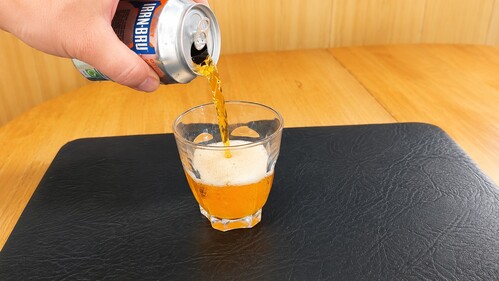 Soda being poured into a glass.