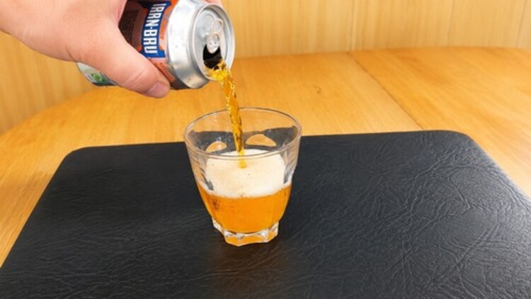 Soda being poured into a glass.