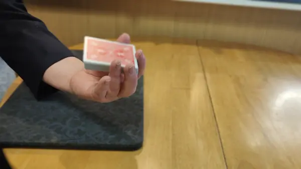 Cards appearing to be snatched from the center of the deck at full speed