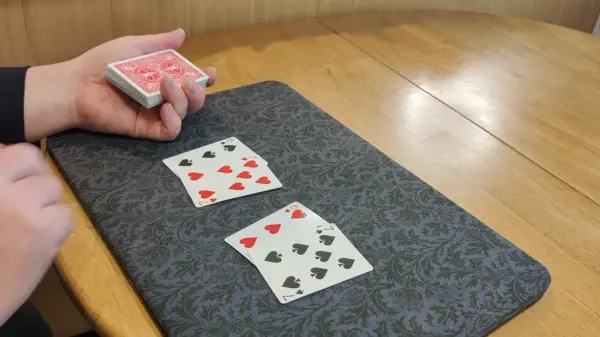 One card being placed on top and its matching card being positioned at the bottom of the deck