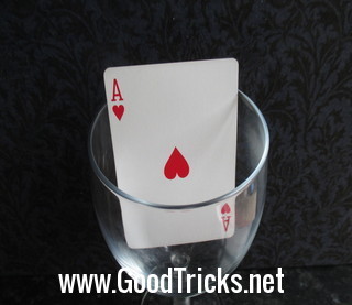 Wine glass containing a red ace as used in the magic in a glass card trick.