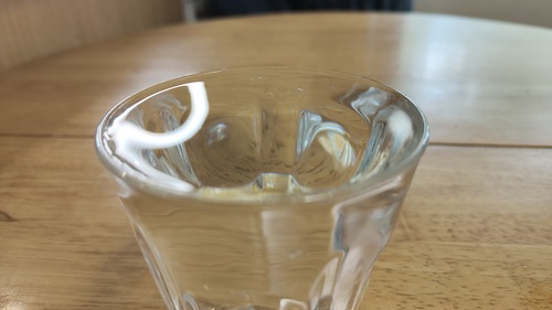 Aglass filled to the brim with water